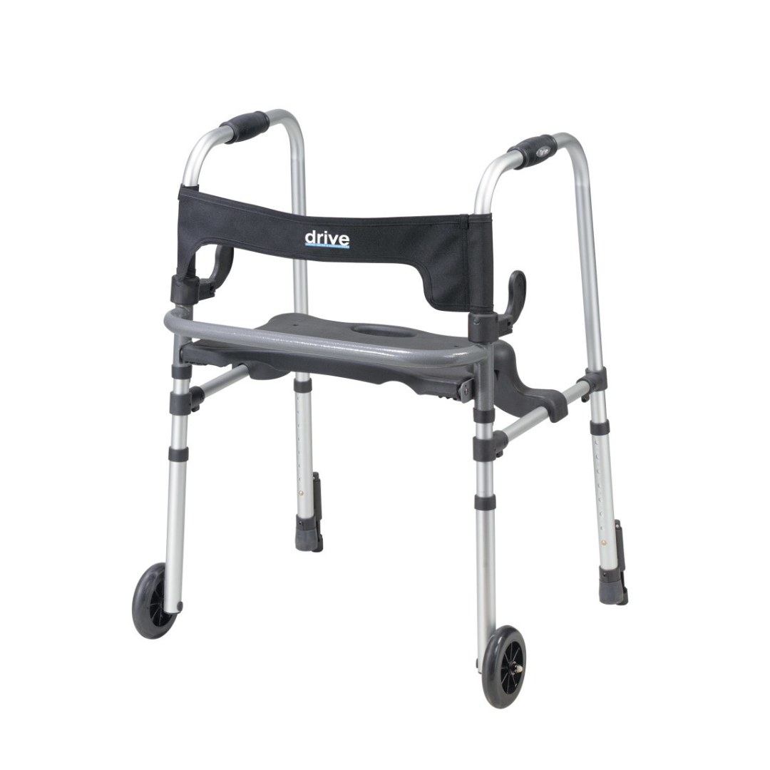 The Drive Clever-Lite LS Walker features a silver frame, two front wheels, rear glide push-down brakes, black hand grips, a black fabric backrest labeled “drive,” and a built-in gray flip-up seat with supportive armrests.